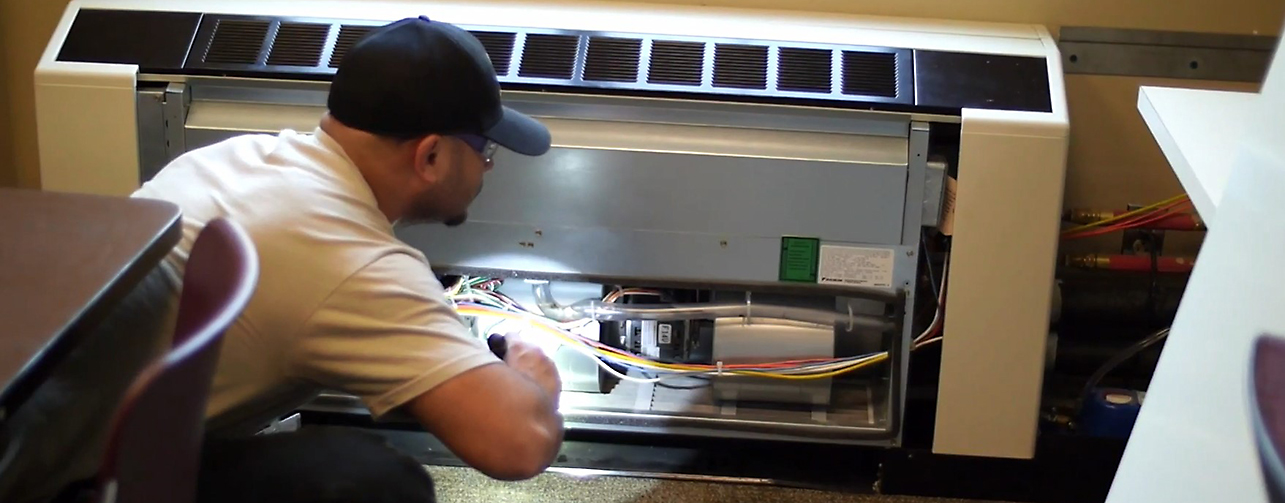 HVAC mechanic inspecting heating unit