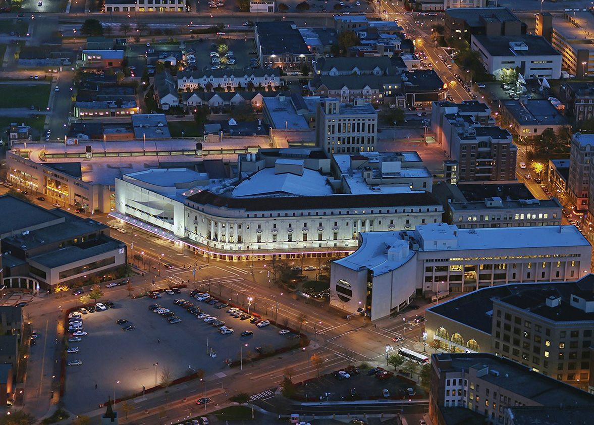 nighttime aerial view of the Eastman Theater and surrounding buildings.