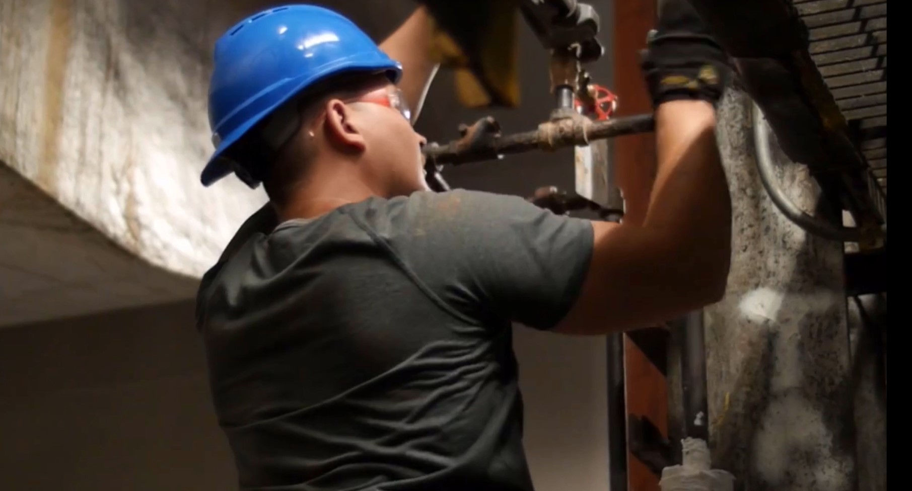 plumber working on copper pipes